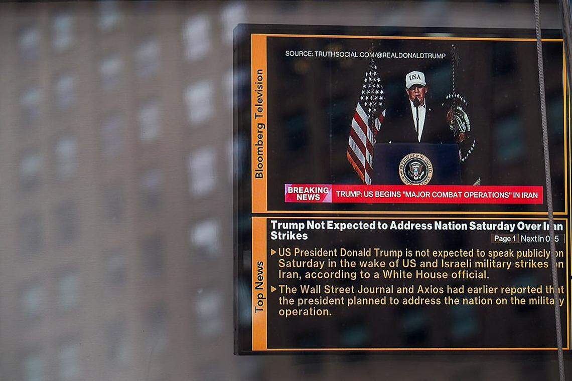 NEW YORK, NEW YORK - FEBRUARY 28: A television at the NASDAQ building in Times Square displays a news headline stating that U.S. led "Major Combat Operations" have begun in Iran, on February 28, 2026 in New York City. U.S. President Donald Trump announced that the United States and Israel had launched an attack on Iran Saturday morning. (Photo by Ryan Murphy/Getty Images)