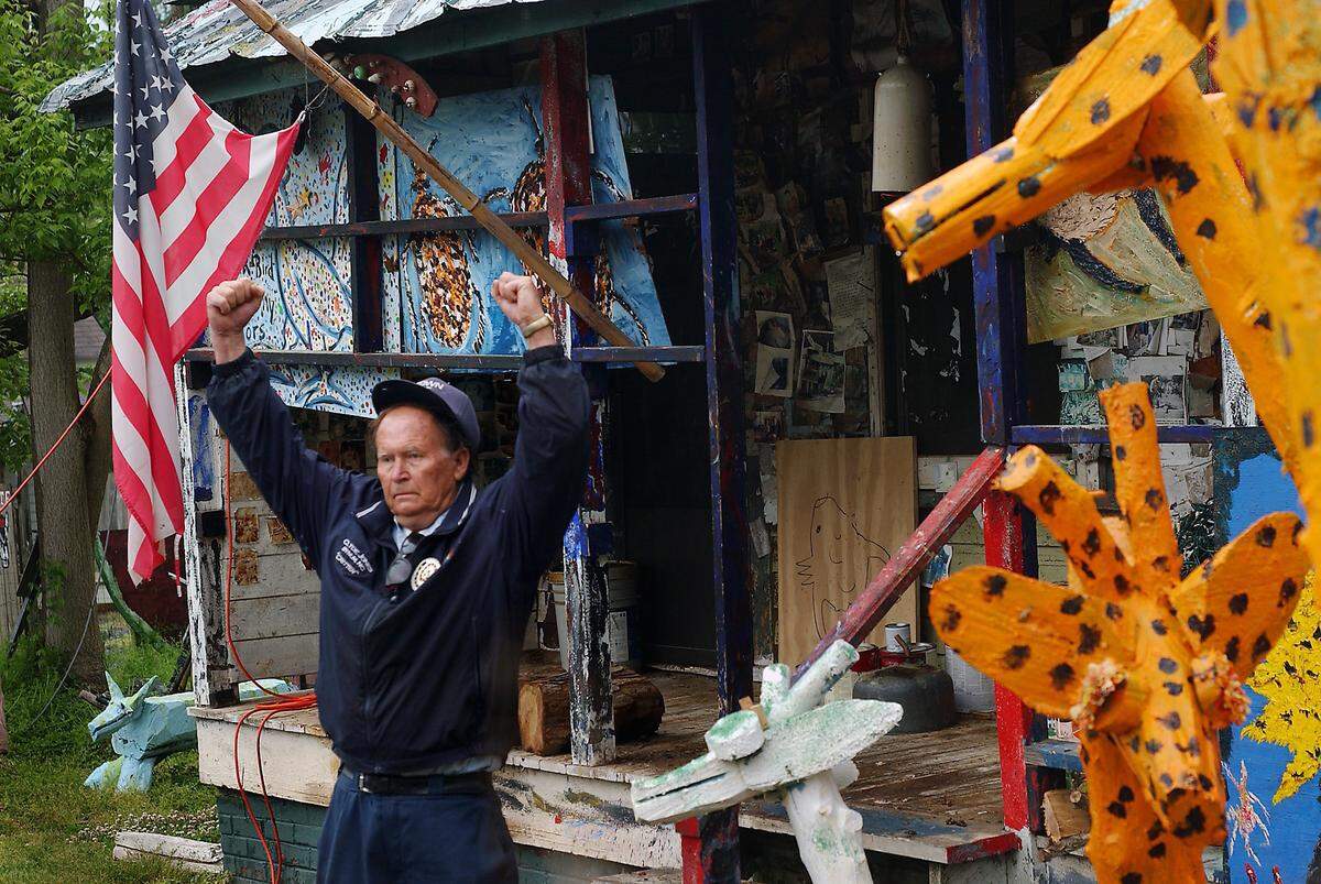 Clyde Jones, a former mill worker turned chainsaw artist, pumps his fists in front of his Bynum home as the second of two wooden giraffes is secured to a trailer, ready for transport to the governor's mansion on April 29, 2005.  The giraffes were to be gifts for the governor's wife, Mary Easley, a day ahead of ClydeFEST 2005.  