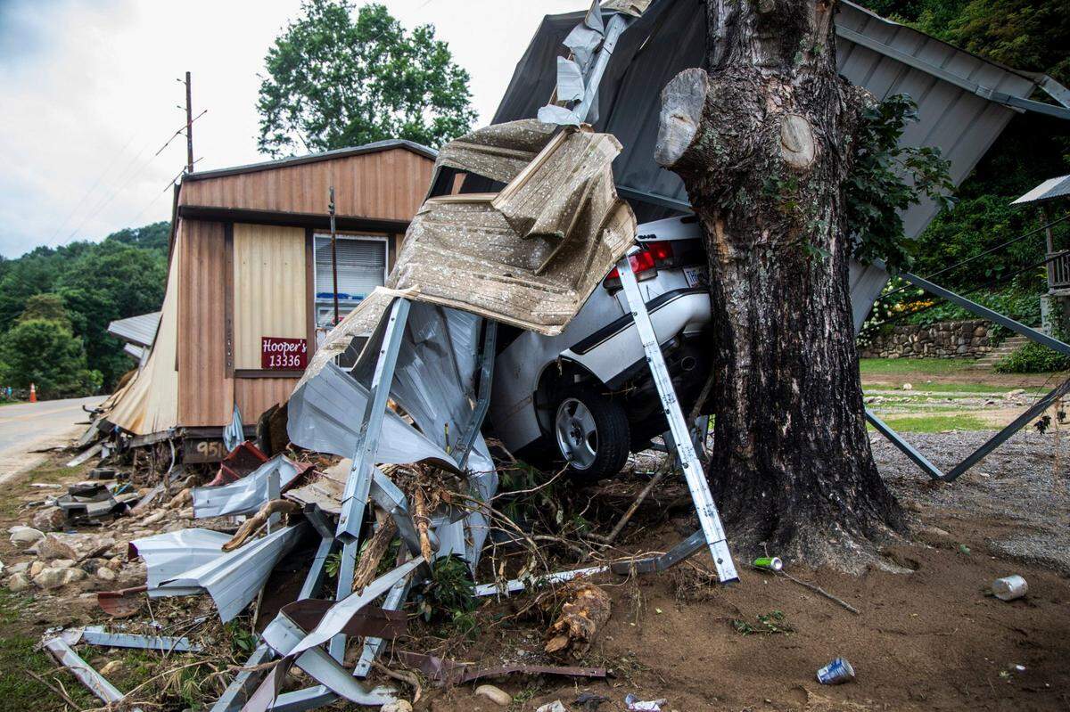 The wreckage of a mobile home and a car lay smashed against a tree on the the East Fork Pigeon River in Cruso Friday, Aug. 20, 2021 after remnants from Tropical Storm Fred caused flooding in parts of Western North Carolina Tuesday. Five people are missing and at least four people were found dead.