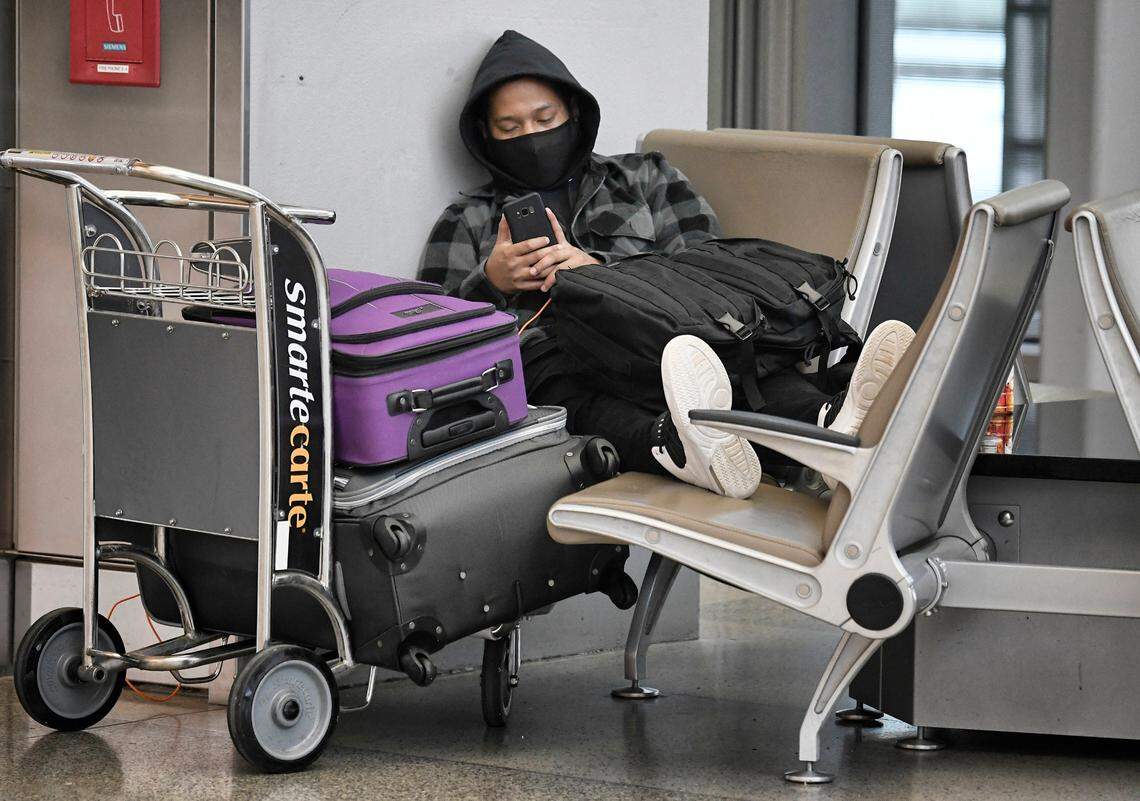 Dudley Skilang waits for his flight at RDU Sunday, January 16, 2022. Skilang was one of the lucky travelers and his flights were still on schedule. He was heading to much warmer conditions in Guam.