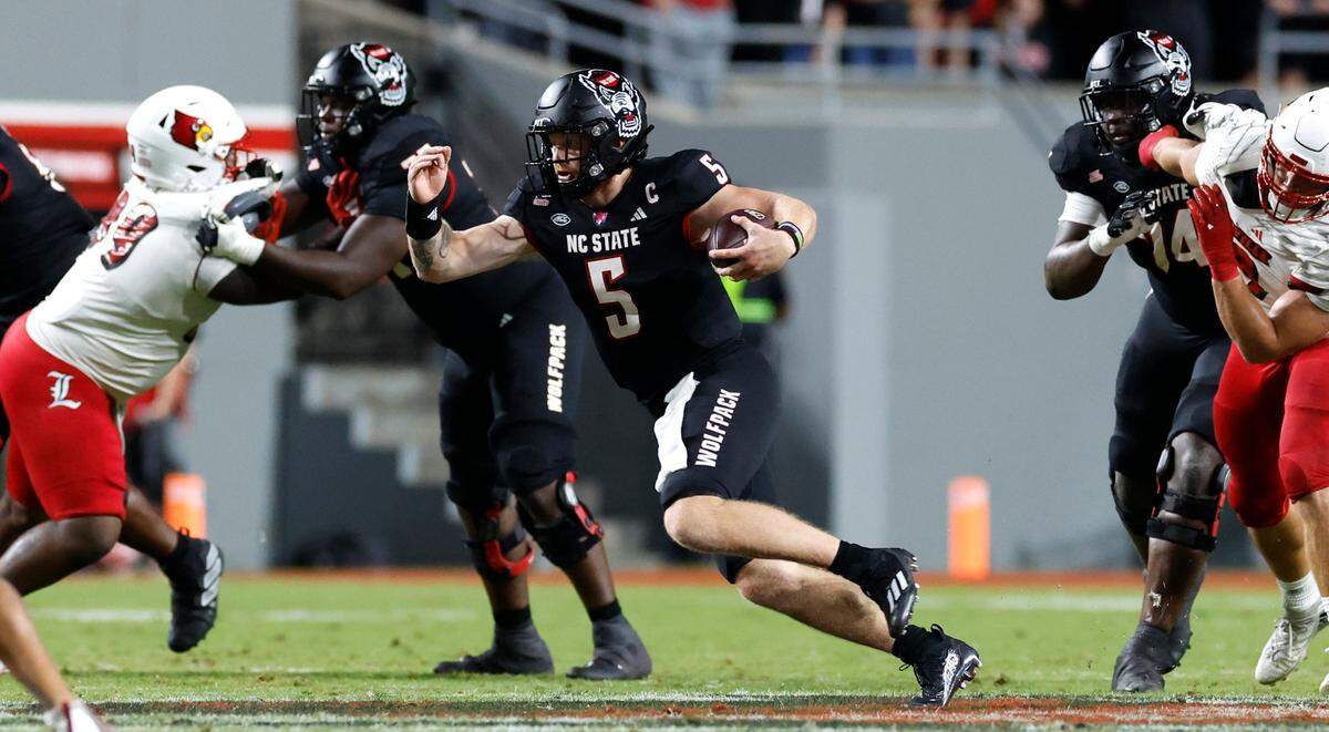 N.C. State quarterback Brennan Armstrong (5) scrambles for yards during the first half of N.C. State’s game against Louisville at Carter-Finley Stadium in Raleigh, N.C., Friday, Sept. 29, 2023.