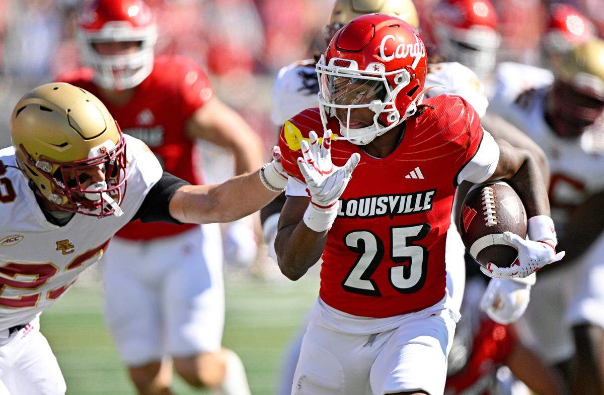 Louisville Cardinals running back Jawhar Jordan (25) avoids the tackle of Boston College Eagles defensive back Cole Batson (23) as he runs for a touchdown during their game in Louisville on Sept. 23, 2023.