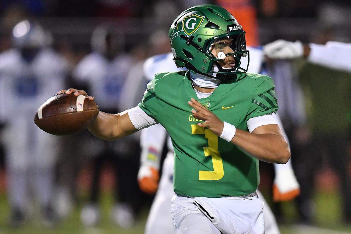 Cardinal Gibbons quarterback Gannon Jones (3) looks top pass downfield against Clayton during the first half. 