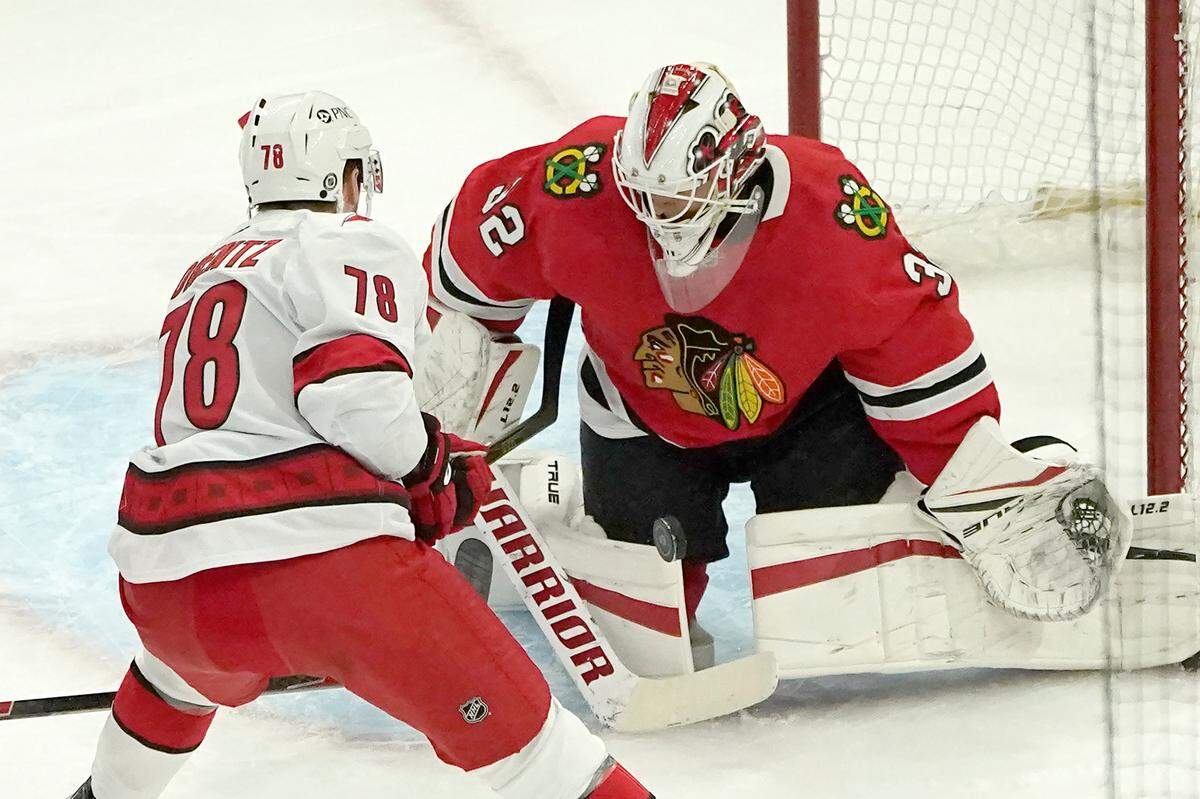 Chicago Blackhawks goaltender Kevin Lankinen, right, makes a save on a point blank shot by Carolina Hurricanes’ Steven Lorentz during the first period of an NHL hockey game Tuesday, March 30, 2021, in Chicago. (AP Photo/Charles Rex Arbogast)