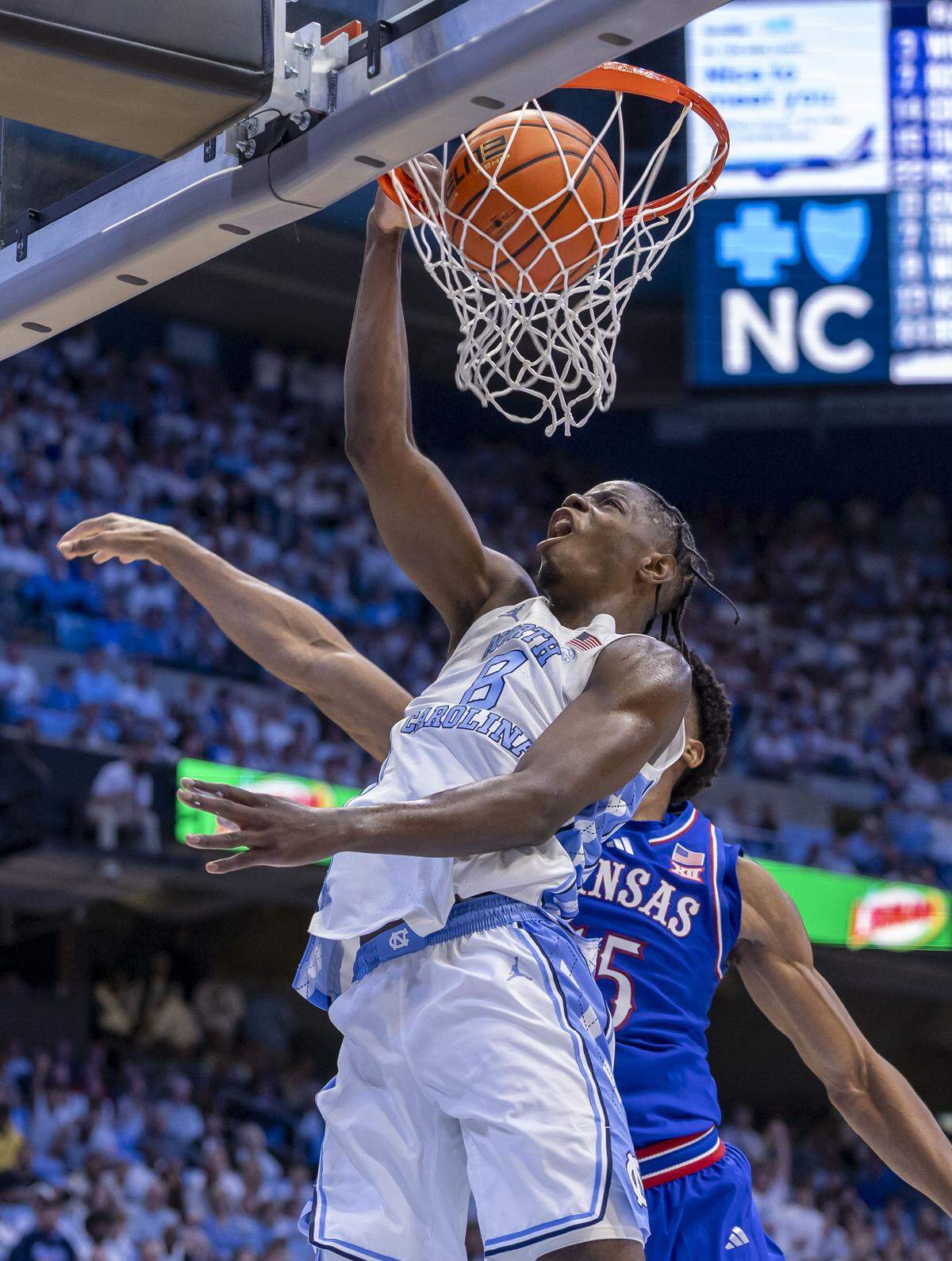 North Carolina forward Caleb Wilson (8) dunks over Kansas forward Bryson Tiller (15) in the first half on Friday, November 7, 2025 at the Smith Center in Chapel Hill, N.C.