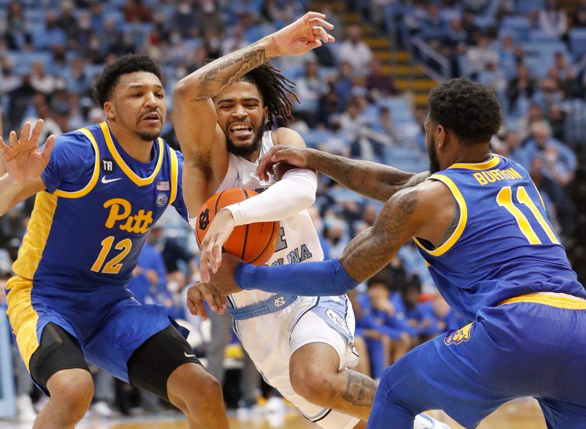 North Carolina’s R.J. Davis (4) is fouled by Pittsburgh’s Jamarius Burton (11) during the second half of Pitt’s 76-67 victory over UNC at the Smith Center in Chapel Hill, N.C., Wednesday, Feb. 16, 2022.