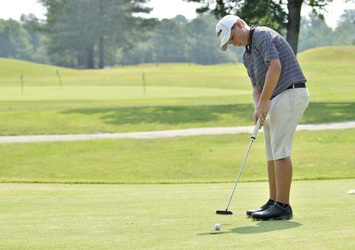 Zebulon golfer Blake McShea gets up and down for par on the par-4 ninth hole at Wendell Country Club during the Eastern N.C. Junior Golf League match on Tuesday, July 15, 2014.
