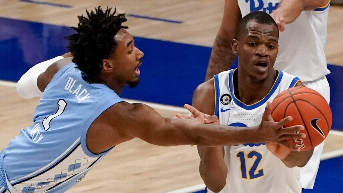North Carolina’s Leaky Black (1) tips a pass away from Pittsburgh’s Abdoul Karim Coulibaly (12) during the first half of an NCAA college basketball game Tuesday, Jan. 26, 2021, in Pittsburgh.