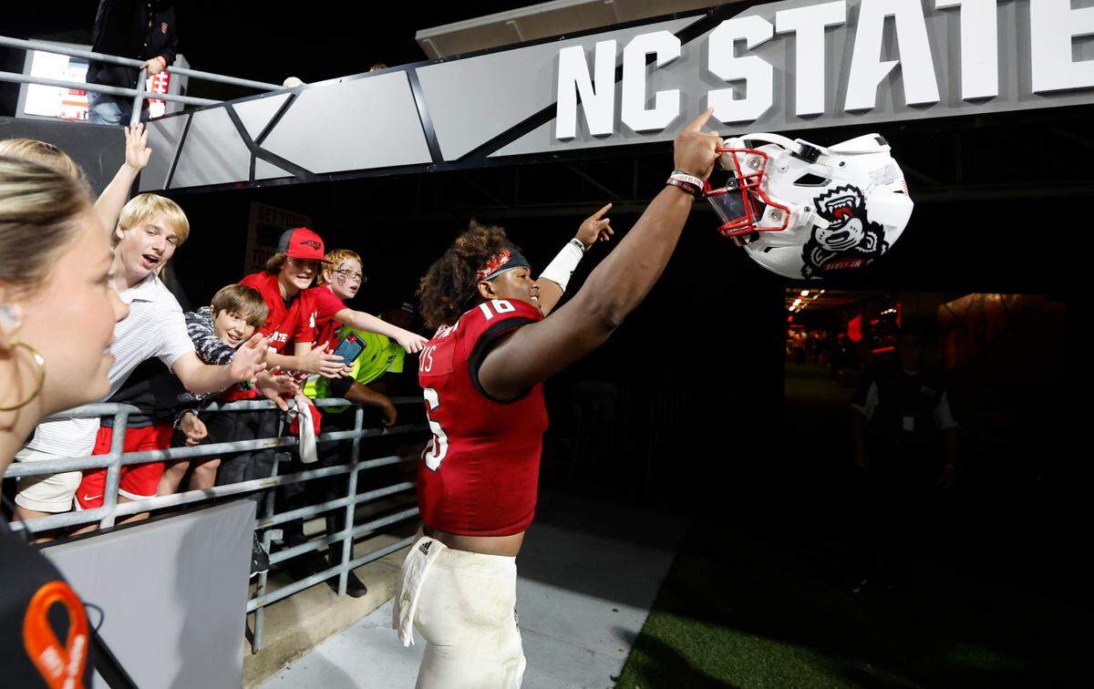 N.C. State quarterback MJ Morris (16) acknowledges the crowds as he heads to the locker room after N.C. State’s 30-21 victory over Wake Forest at Carter-Finley Stadium in Raleigh, N.C., Saturday, Nov. 5, 2022.
