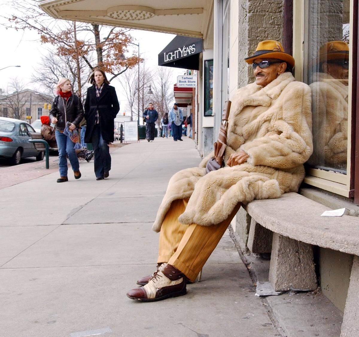 Frank T. Wright, known locally as the snappiest dresser in Chapel Hill, wears a fur coat over his yellow suit while waiting for a bus Tuesday, February 1, 2005 on East Franklin Street in Chapel Hill.