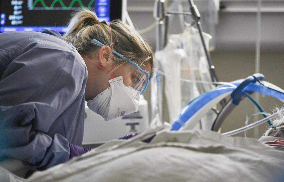 Katie Downey, RN, cares for a COVID patient in the Medical Intensive Care Unit at UNC Hospital in Chapel Hill, N.C., on Wednesday, Aug. 11, 2021.