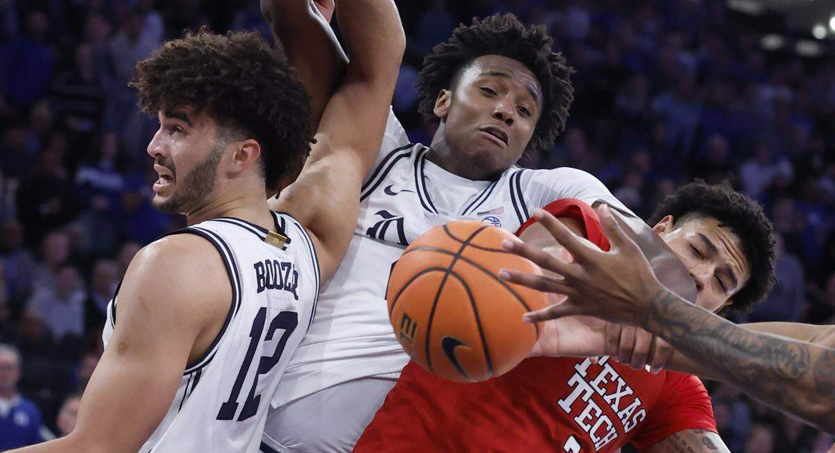 Duke’s Cameron Boozer (12), Patrick Ngongba II (21) and Texas Tech's Lejuan Watts go after the rebound during the first half of Duke’s game against Texas Tech in the SentinelOne Classic at Madison Square Garden in New York City on Saturday, Dec. 20, 2025.
