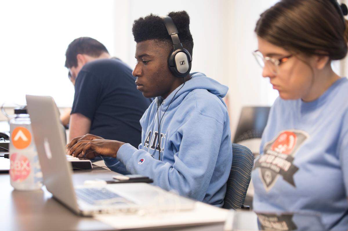 Isaiah Caldwell, middle, and Alexis Dunlap, right, work on their music projects in Kerwin Young’s beat making class in Hill Hall at UNC-Chapel Hill on Wednesday, June 12, 2019.