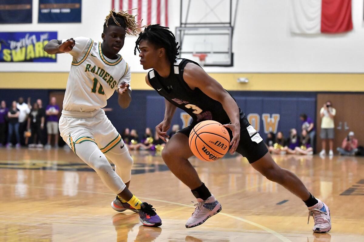 Holly Springs’ Micah Jones (3) drives the basket against Richmond’s Jayden Hamilton (10) during the first half. The Richmond Raiders and the Holly Springs Golden Hawks met in the NCHSAA 4A East Regional Finals in Sanford, N.C. on March 4, 2023.