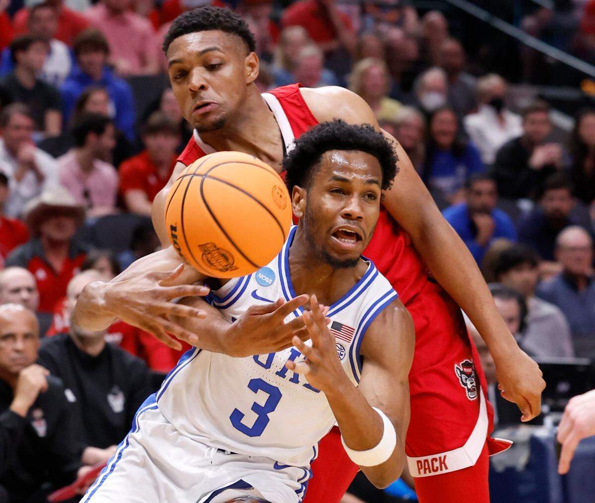 N.C. State’s Casey Morsell (14) knocks the ball from Duke’s Jeremy Roach (3) during the first half of N.C. State’s game against Duke in their NCAA Tournament Elite Eight matchup at the American Airlines Center in Dallas, Texas, Sunday, March 31, 2024.