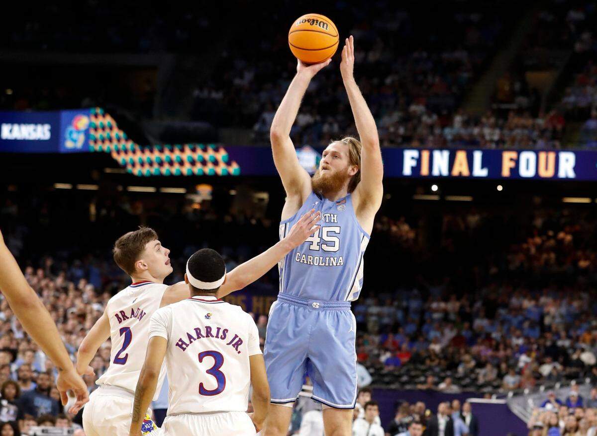 North Carolina’s Brady Manek (45) shoots as Kansas’ Christian Braun (2) defends during the first half of UNCís game against Kansas in the NCAA Menís National Championship at the Caesars Superdome in New Orleans, La., Monday, April 4, 2022.
