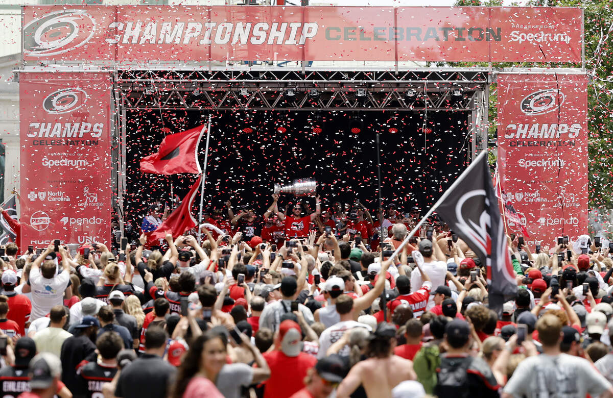 Carolina's Jordan Staal raises the Cup at the end of the rally for the Carolina Hurricanes in downtown Raleigh Saturday, June 20, 2026.