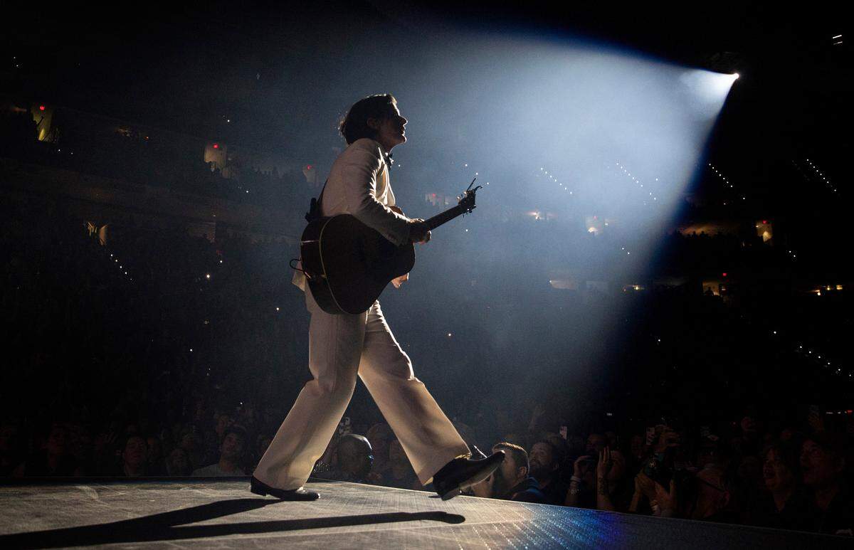The spotlight illuminates Seth Avett as The Avett Brothers play Raleigh’s PNC Arena for their annual New Year’s Eve show.