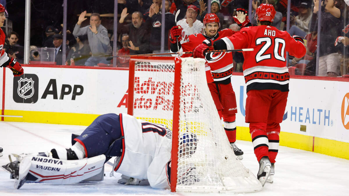 Carolina center Seth Jarvis (24) celebrates with Sebastian Aho (20) after Jarvis scored during the second period of the Carolina Hurricanes game against the Columbus Blue Jackets at PNC Arena in Raleigh, N.C., Wednesday, Oct. 12, 2022.