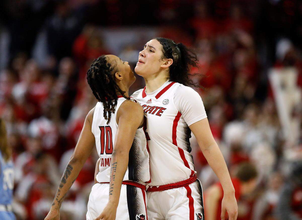 N.C. State’s Aziaha James and Mimi Collins celebrate after James drew an offensive foul during the second half of the Wolfpack’s 63-59 win over North Carolina on Thursday, Feb. 1, 2024, at Reynolds Coliseum in Raleigh, N.C.