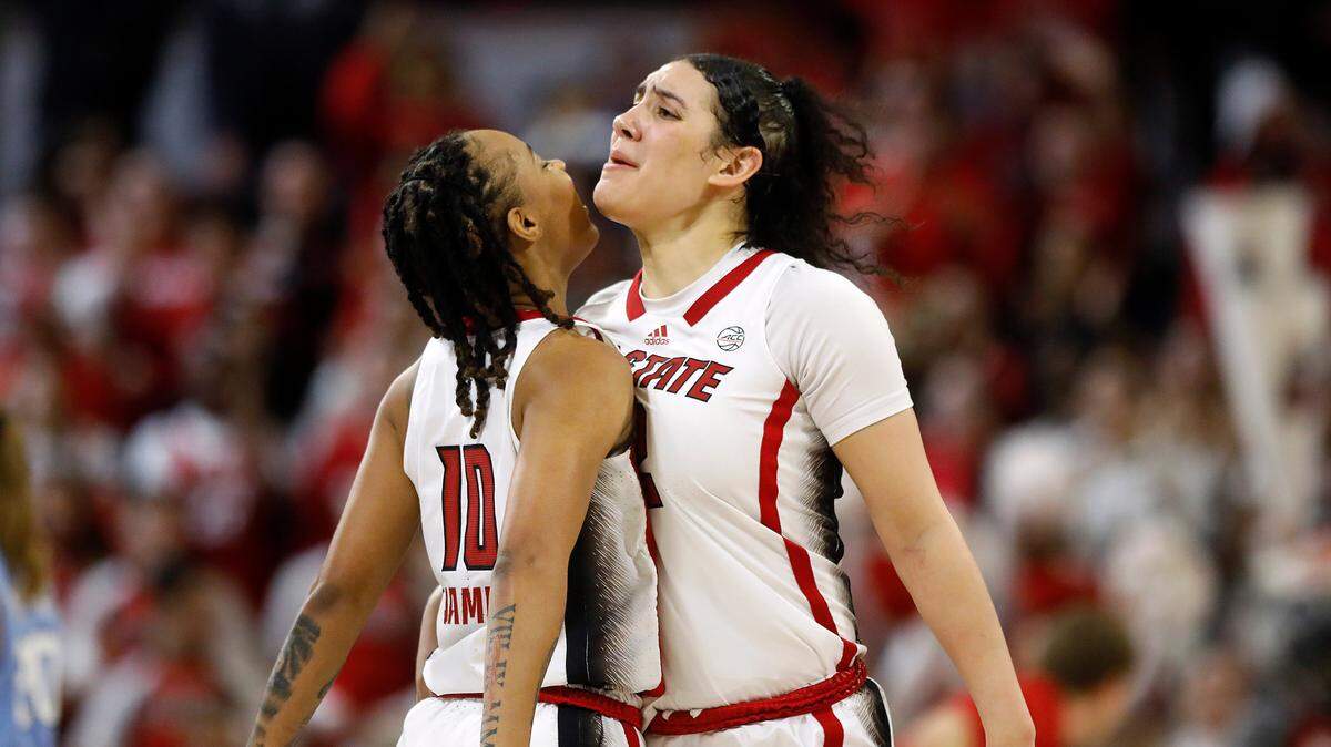 N.C. State’s Aziaha James and Mimi Collins celebrate after James drew an offensive foul during the second half of the Wolfpack’s 63-59 win over North Carolina on Thursday, Feb. 1, 2024, at Reynolds Coliseum in Raleigh, N.C.