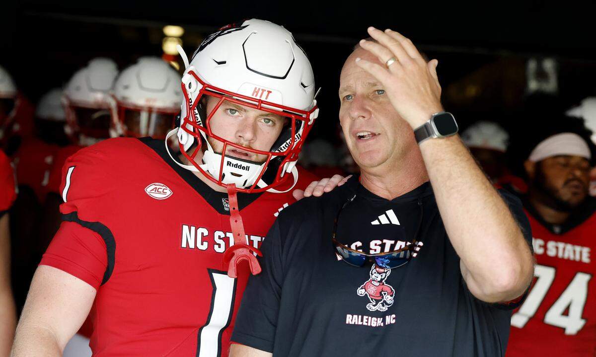 N.C. State head coach Dave Doeren talks to Caden Fordham (1) before they run out onto the field to warmup before N.C. State’s game against Virginia at Carter-Finley Stadium in Raleigh, N.C., Sat. Sept. 6, 2025.