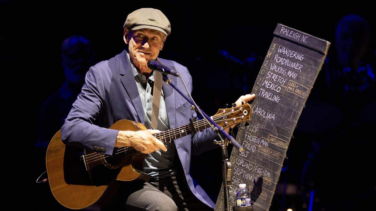 James Taylor holds up his setlist after a fan shouted out a request during his concert in Raleigh, N.C., Thursday night, Sept. 4, 2025.