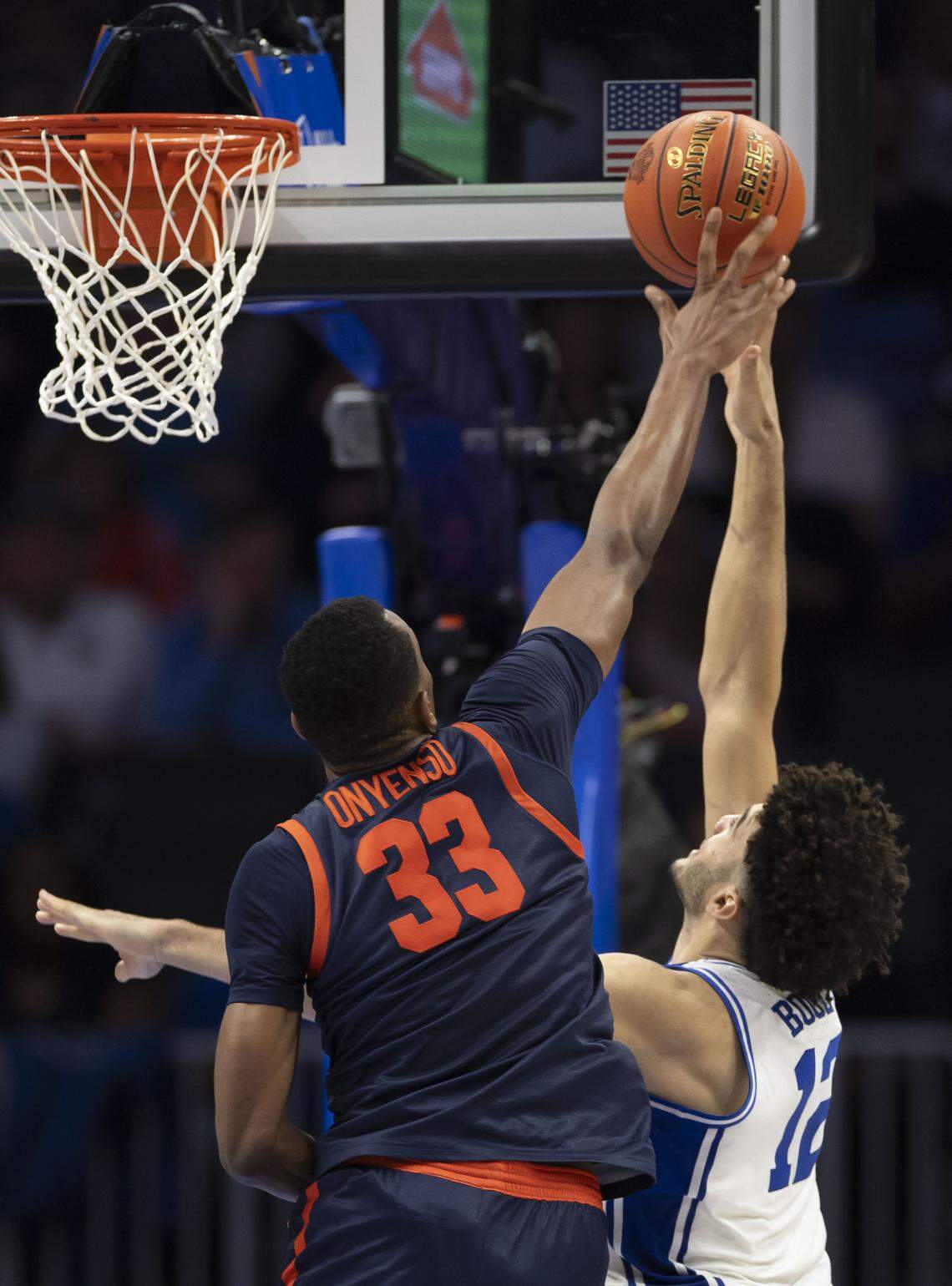 Virginia center Ugonna Onyenso (33) blocks a shot by Duke forward Cameron Boozer (12) in the second half on Saturday, March 14, 2026, during the ACC Tournament Championship at Spectrum Center in Charlotte, N.C. Onyenso had nine blocks in the game. 