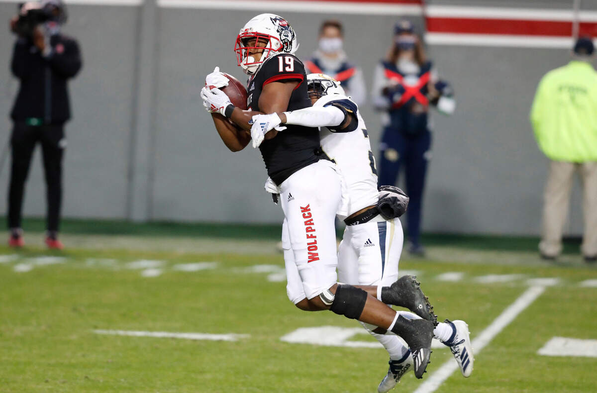 N.C. State wide receiver C.J. Riley (19) pulls in a reception while defended by Georgia Tech defensive back Kenan Johnson (24) during the first half of N.C. State’s game against Georgia Tech at Carter-Finley Stadium in Raleigh, N.C., Saturday, Dec. 5, 2020.