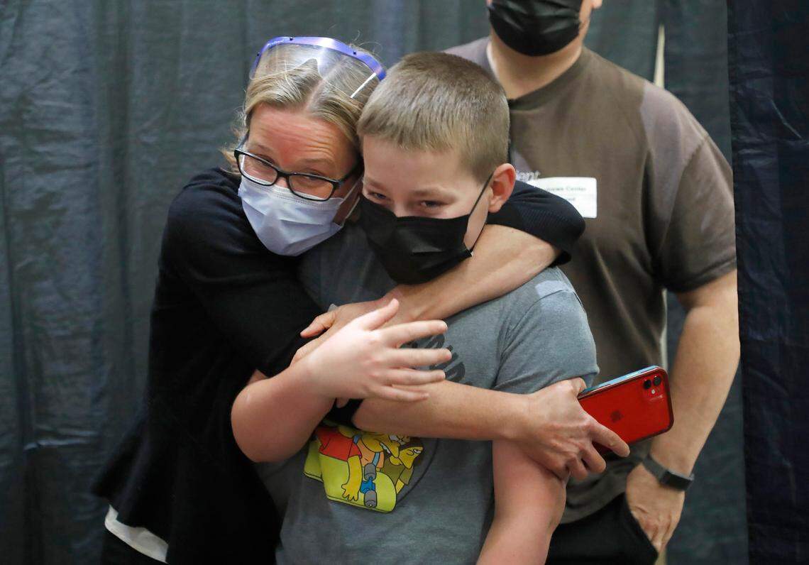 Laura Parrish hugs her son, Nathan, 12, after he received his first COVID-19 vaccine shot at the WakeMed Raleigh Campus Thursday, May 13, 2021. Thursday was the first day that the Pfizer vaccine was being offered to children age 12 to 15 after the CDC approved of use on Wednesday.
