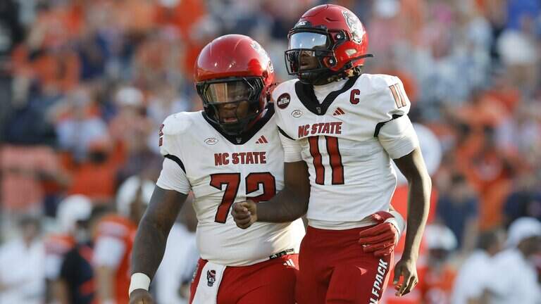 NC State football opens the season with big loss at Virginia. See photos from Week 0 game