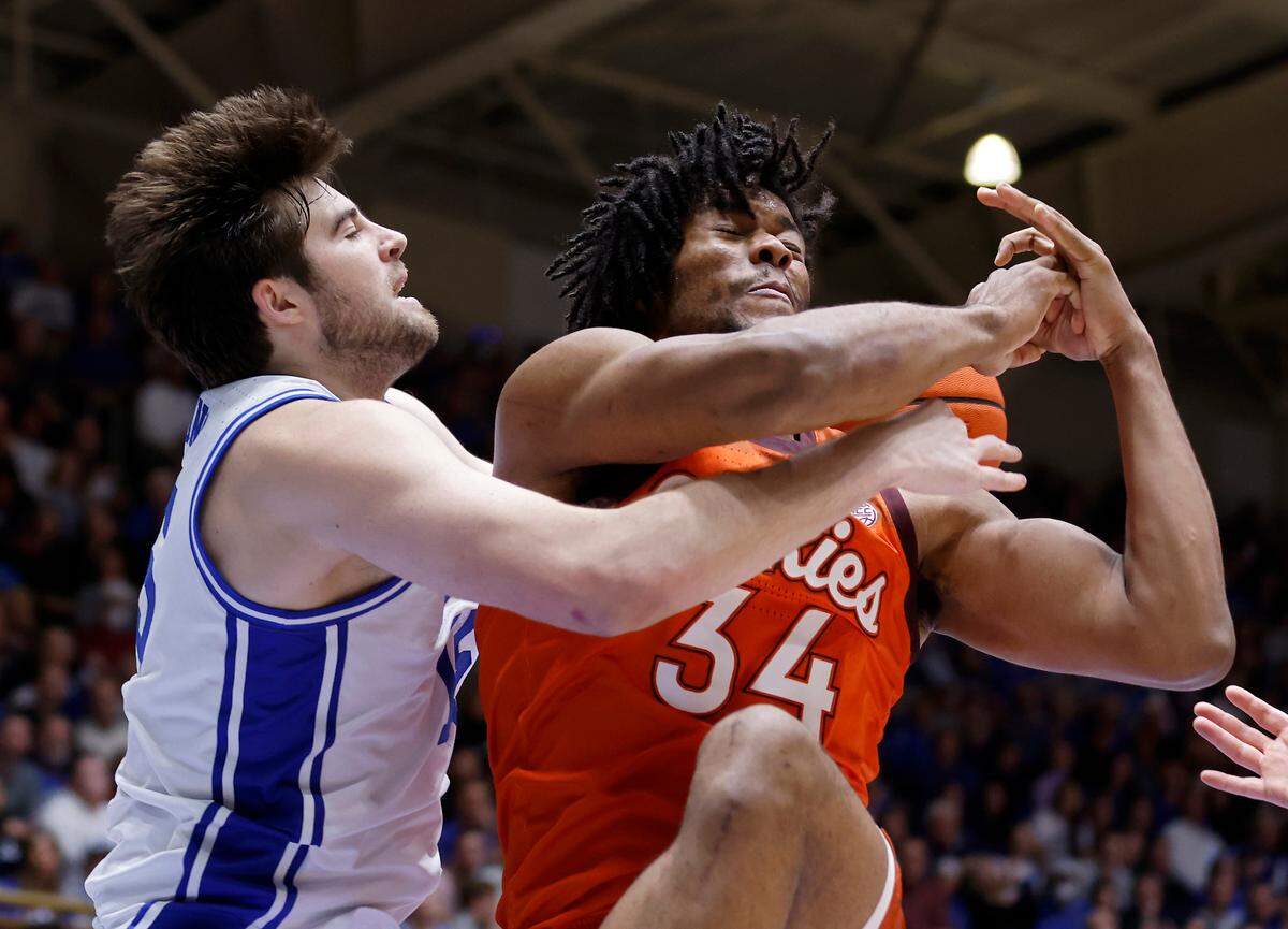 Duke’s Ryan Young and Virginia Tech’s Mylyjael Poteat battle for possession during the second half of the Blue Devils’ 81-65 win over Virginia Tech on Saturday, Feb. 25, 2023, at Cameron Indoor Stadium in Durham, N.C.