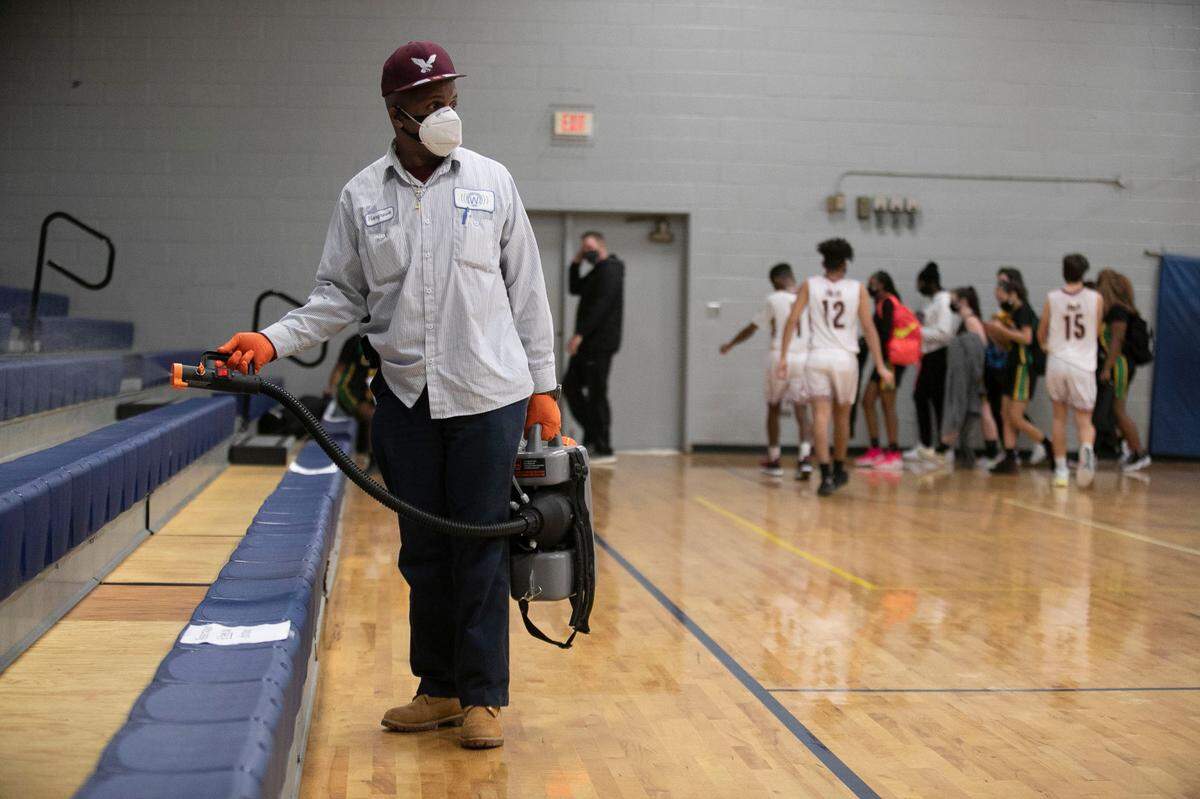 John Hargrove disinfects the John Graham Gym between games to insure safety during the COVID-19 pandemic on Tuesday, February, 2, 2021 in Warrenton, N.C.