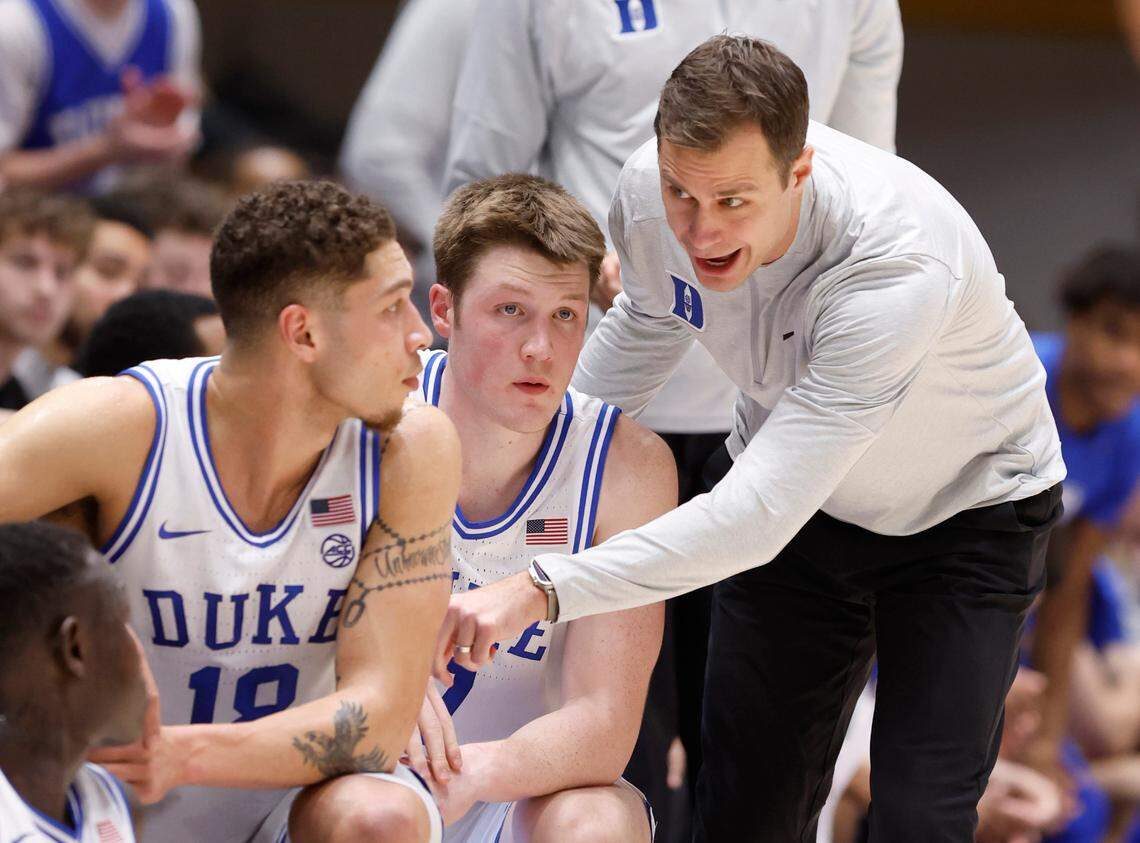 Duke head coach Jon Scheyer talks with Mason Gillis (18) and Kon Knueppel (7) before they take the court during the first half of Duke’s game against Miami at Cameron Indoor Stadium in Durham, N.C., Tuesday, Jan. 14, 2025.