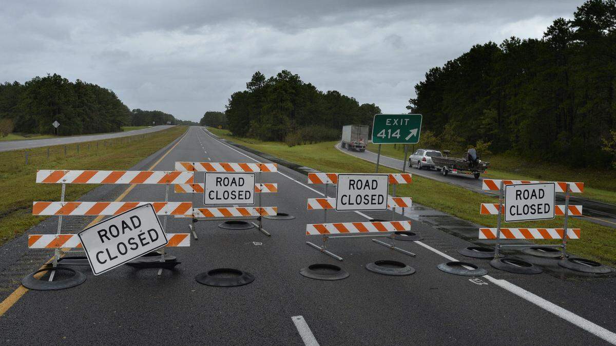 In this 2018 file photo, Interstate 40 westbound is closed to traffic at the Cable Hayne exit Sunday, September 16, 2018 in Wilmington, N.C. due to flooding caused by Hurricane Florence.