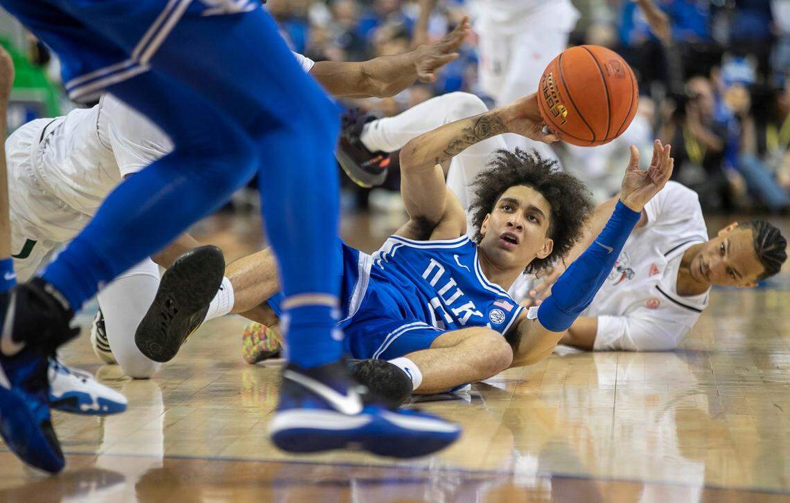 Duke’s Tyrese Proctor (5) hits the court with Miami’s Isaiah Wong (2) to secure a loose ball in the second half during in the semi-finals of the ACC Tournament on Friday, March 10, 2023 at the Greensboro Coliseum in Greensboro, N.C.