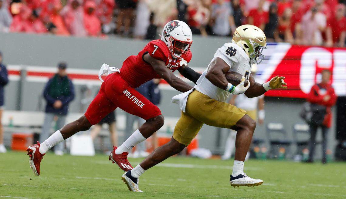 Notre Dame running back Audric Estime (7) escapes from N.C. State cornerback Shyheim Battle (7) as Estime runs for a 80-yard touchdown run during the first half of N.C. State’s game against Notre Dame at Carter-Finley Stadium in Raleigh, N.C., Saturday, Sept. 9, 2023.