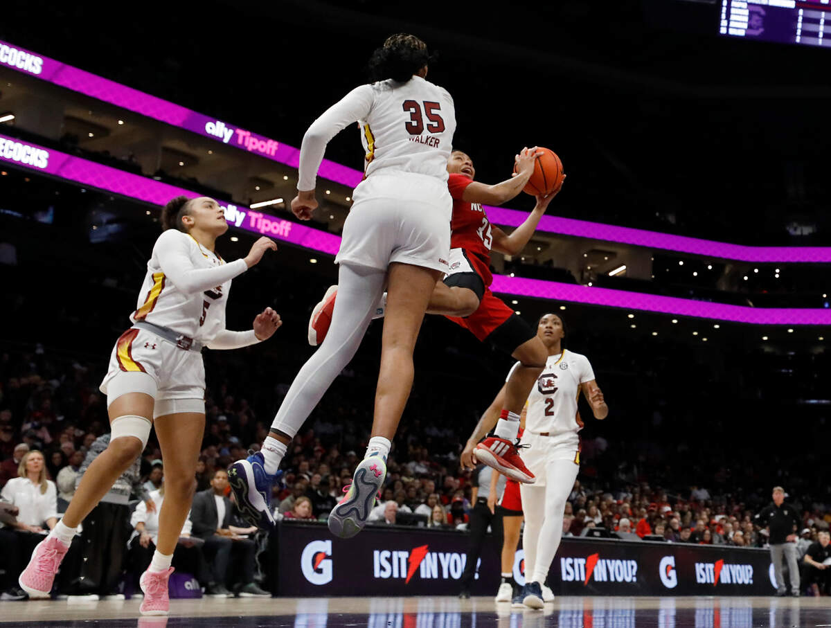 N.C. State’s Zoe Brooks drives around South Carolina’s Sakima Walker during the first half of the Wolfpack’s 71-57 loss on Sunday, Nov. 10, 2024, at Spectrum Center in Charlotte, N.C.