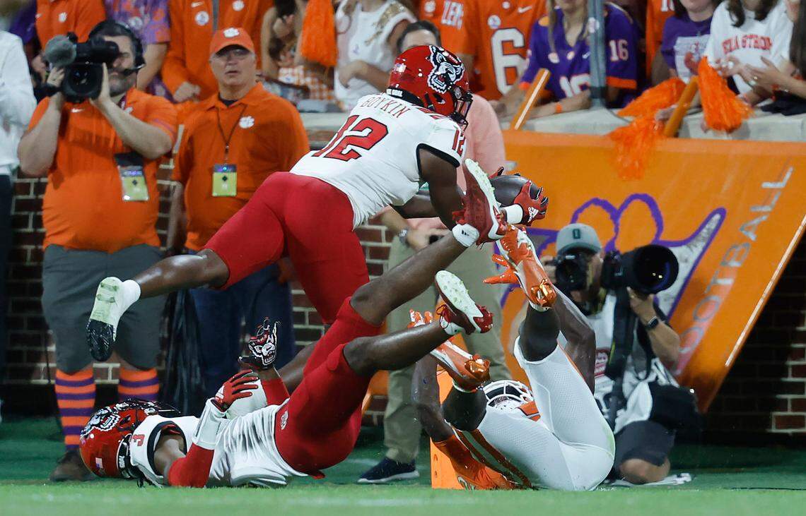 N.C. State defensive back Devan Boykin (12) can’t pull in the potential interception after cornerback Aydan White (3) batted the pass away from Clemson wide receiver Joseph Ngata (10) late in the first half of N.C. State’s game against Clemson at Memorial Stadium in Clemson, S.C., Saturday, Oct. 1, 2022.