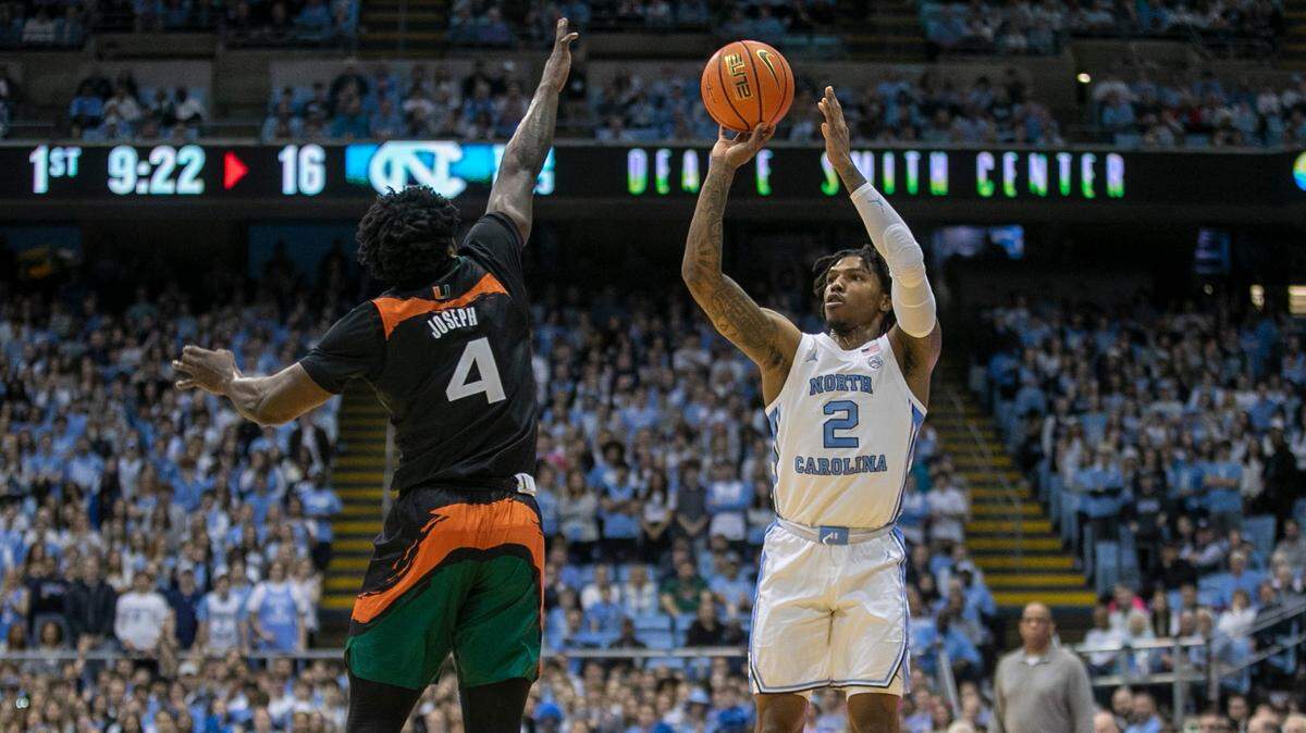 North Carolina’s Caleb Love (2) puts up a shot against Miami’s Bensely Joseph (4) in the first half on Monday, February 13, 2023 at the Smith Center in Chapel