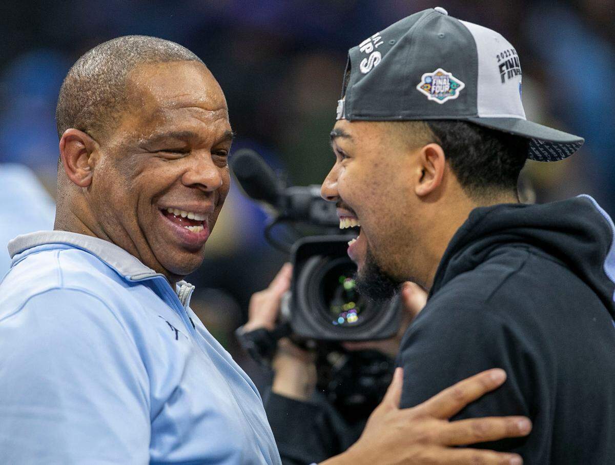Elijah Davis embraces his father Hubert Davis as they celebrate the Tar Heels’ victory over Saint Peter’s in the NCAA East Regional final on Sunday, March 27, 2022 at Wells Fargo Center in Philadelphia, Pa