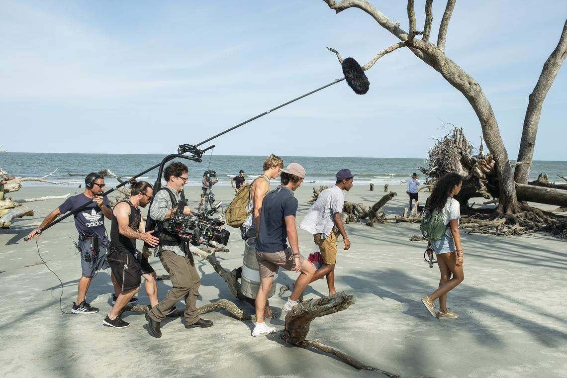 The cast and crew of Netflix’s “Outer Banks” walk along a South Carolina while filming the new series there in July 2019.