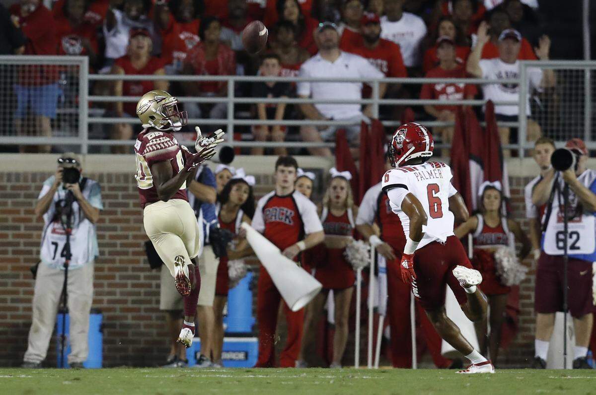 Florida State wide receiver Ontaria Wilson (80) catches a 40-yard touchdown reception as N.C. State cornerback Taiyon Palmer (6) defends during the first half of N.C. State’s game against Florida State at Doak Campbell Stadium in Tallahassee, Fla., Saturday, Sept. 28, 2019.