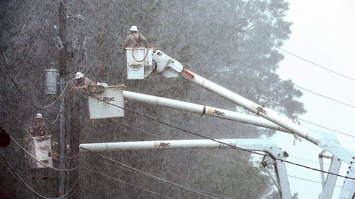 Electrical linemen crews works in a rainstorm near Lake Crabtree in Wake County in 2014 as they repair damage to power lines. As the technical skills gap become more apparent and a four-year degree more costly, policymakers are focusing on the state Community College System.