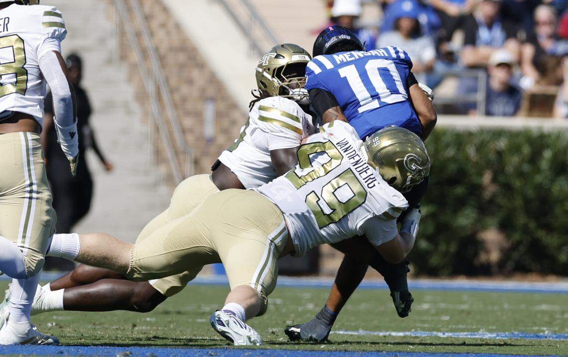 Duke quarterback Darian Mensah (10) is sacked by Georgia Tech’s Amontrae Bradford (98) and Jordan van den Berg (99) during the first half of Duke’s game against Georgia Tech at Wallace Wade Stadium in Durham, N.C., Saturday, Oct. 18, 2025.