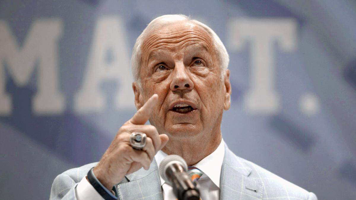 North Carolina coach Roy Williams points to the rafters of the Smith Center acknowledging the players he has coached and the three National Championships he won as he announced his retirement on Thursday, April 1, 2021 in Chapel Hill, N.C. Williams had coached for 33 seasons, the last 18 at North Carolina.
