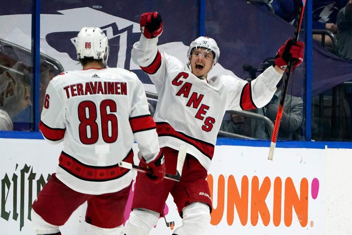 Carolina Hurricanes right wing Sebastian Aho (20) celebrates his goal against the Tampa Bay Lightning with left wing Teuvo Teravainen (86) during the second period in Game 3 of an NHL hockey Stanley Cup second-round playoff series Thursday, June 3, 2021, in Tampa.