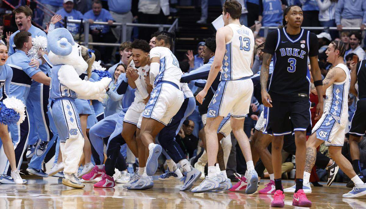 Players mob North Carolina's Seth Trimble (7) after he made the game winning basket in UNC’s 71-68 victory over Duke at the Dean E. Smith Center in Chapel Hill, N.C., Saturday, Feb. 7, 2026.