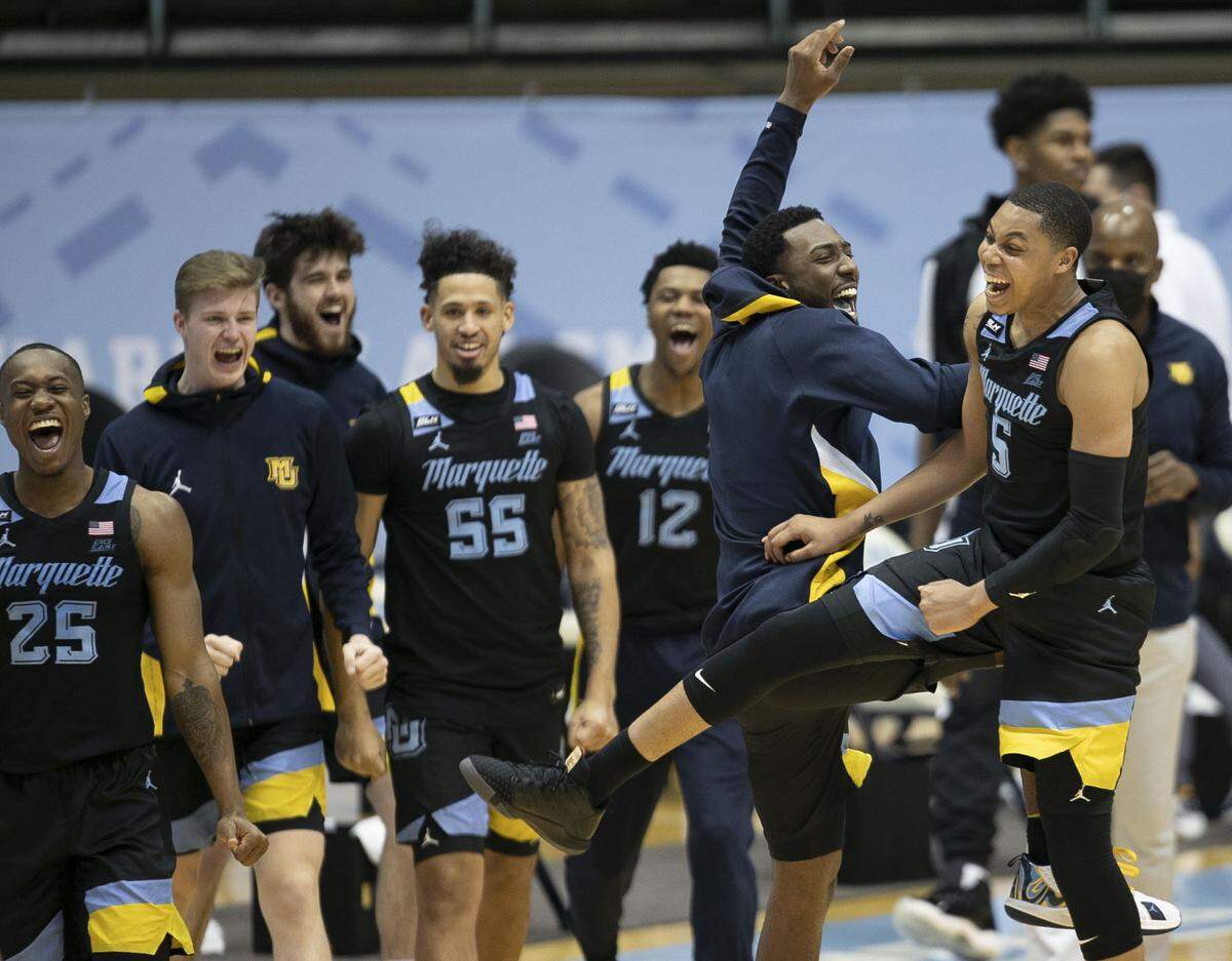 Marquette’s Samir Torrence (10) and Greg Elliott (5) celebrate their 83-70 victory over North Carolina on Wednesday, February 24, 2021 at the Smith Center in Chapel Hill, N.C.