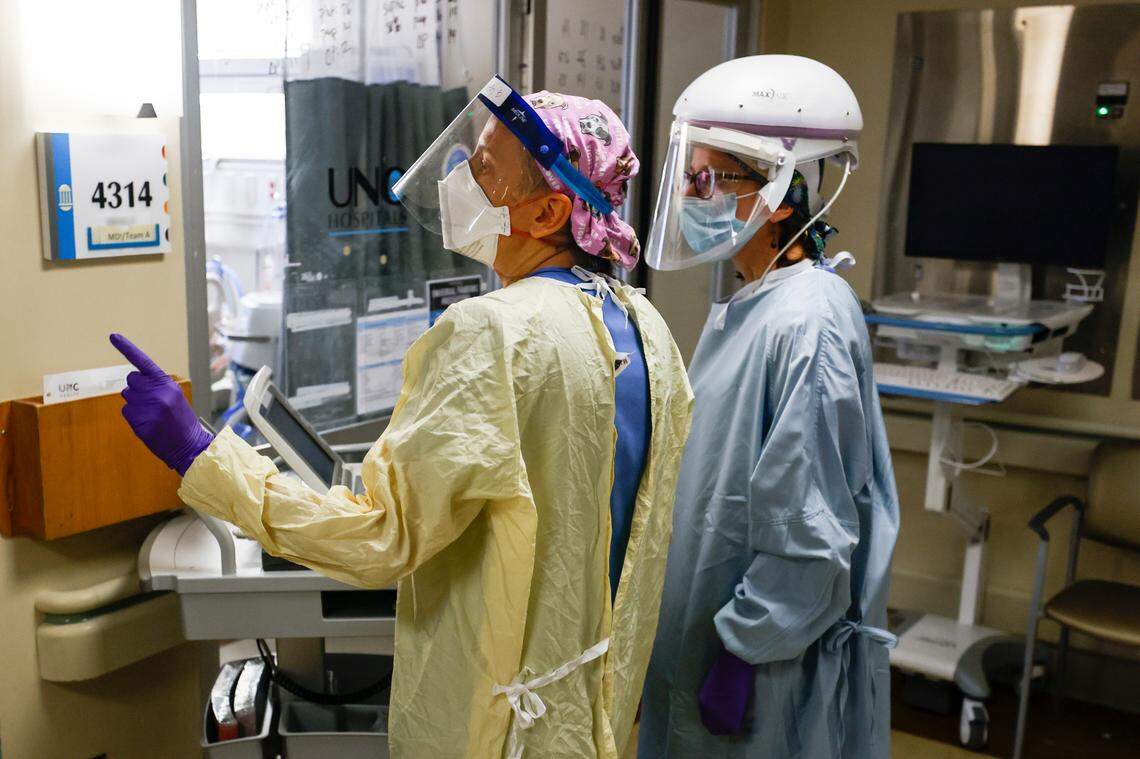Nurses in the Medical Intensive Care Unit consult on COVID pateints in the Medical Intensive Care Unit at UNC Hospital in Chapel Hill, N.C. Wednesday, Aug. 11, 2021.
